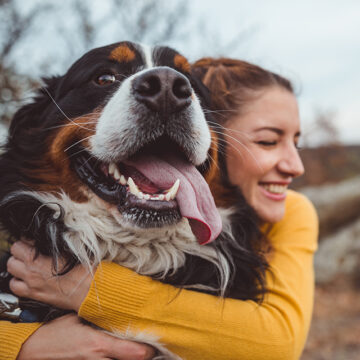 Volunteer Hugging Adoptable Dog